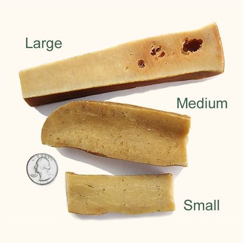 Three pieces of dog chew: small, medium, and large; beige with dark spots